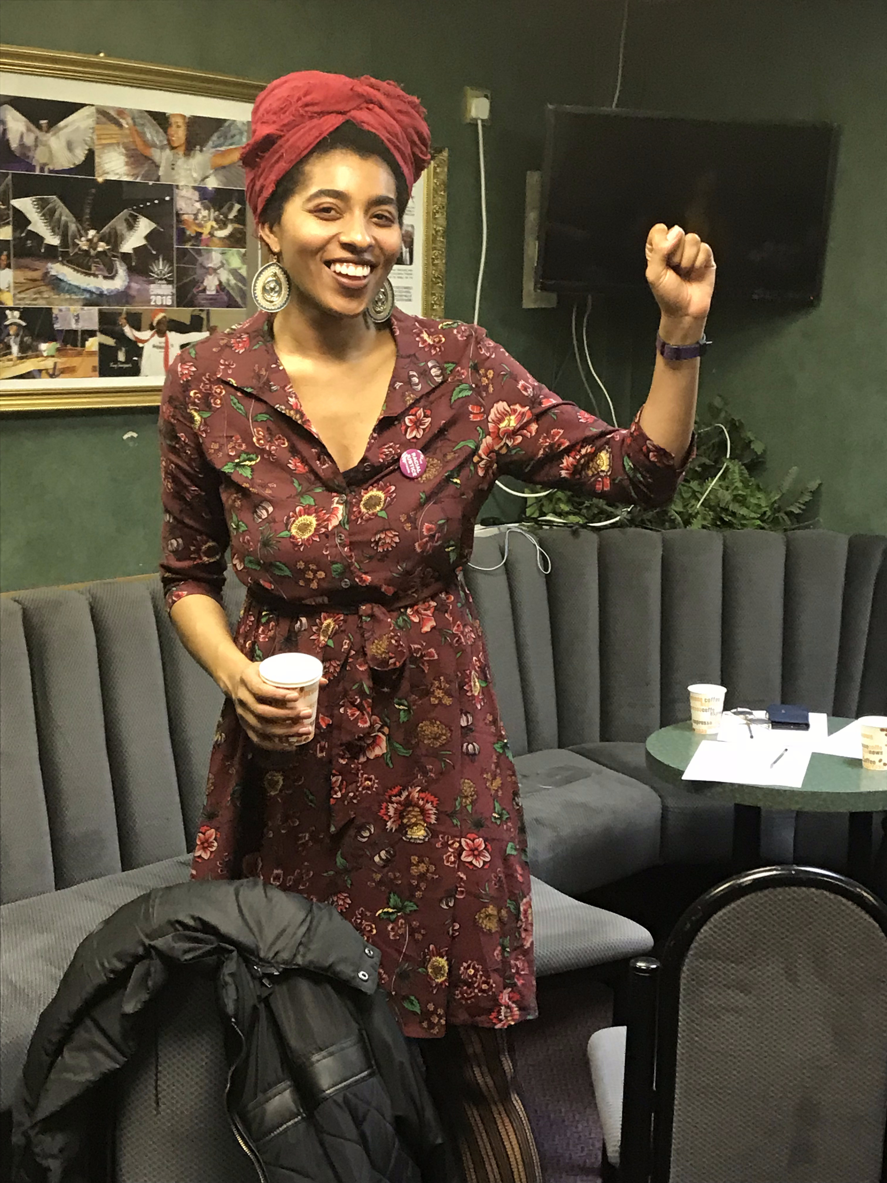 Community member with raised fist at event
