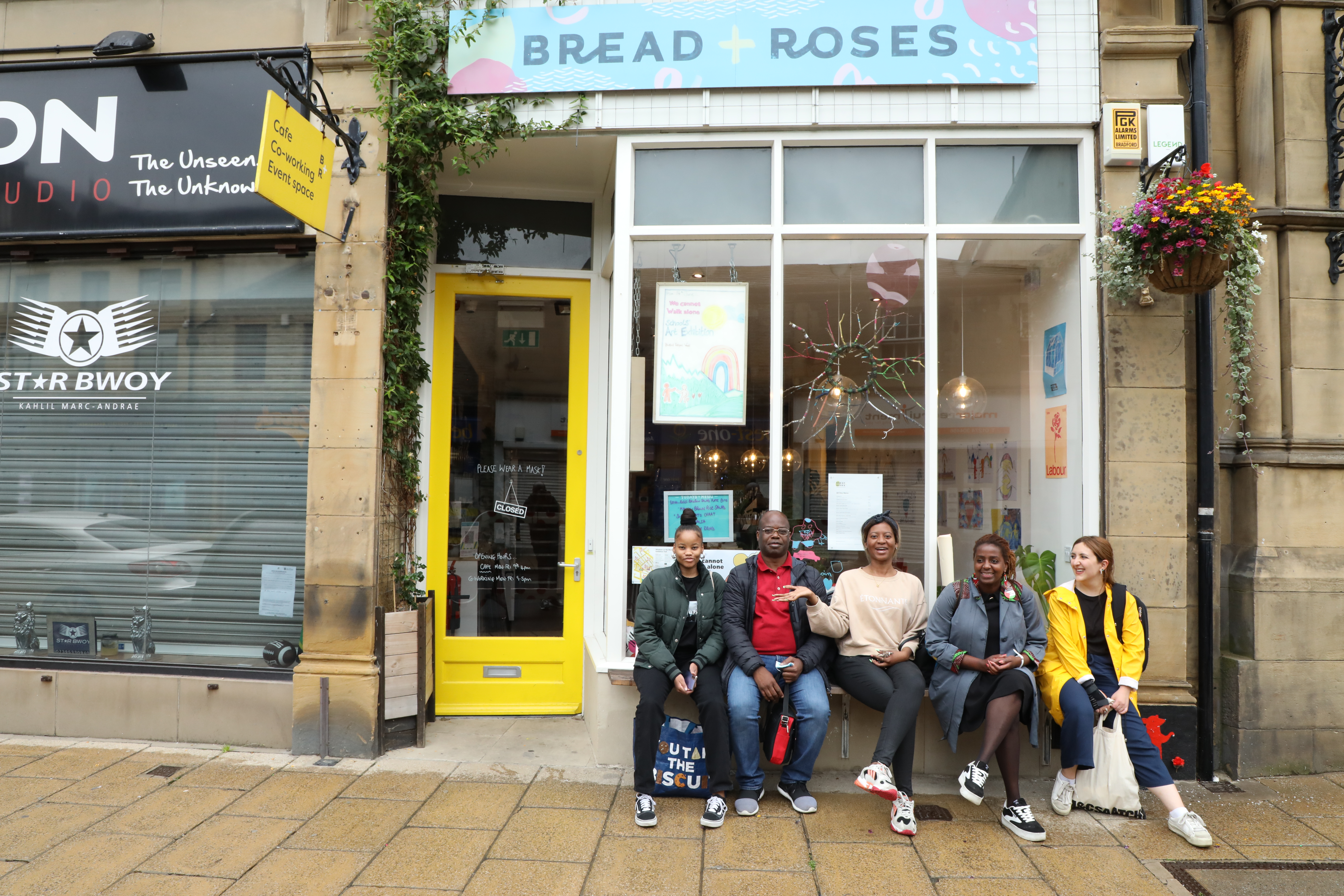 Group on doorstep of Bread and Roses shop