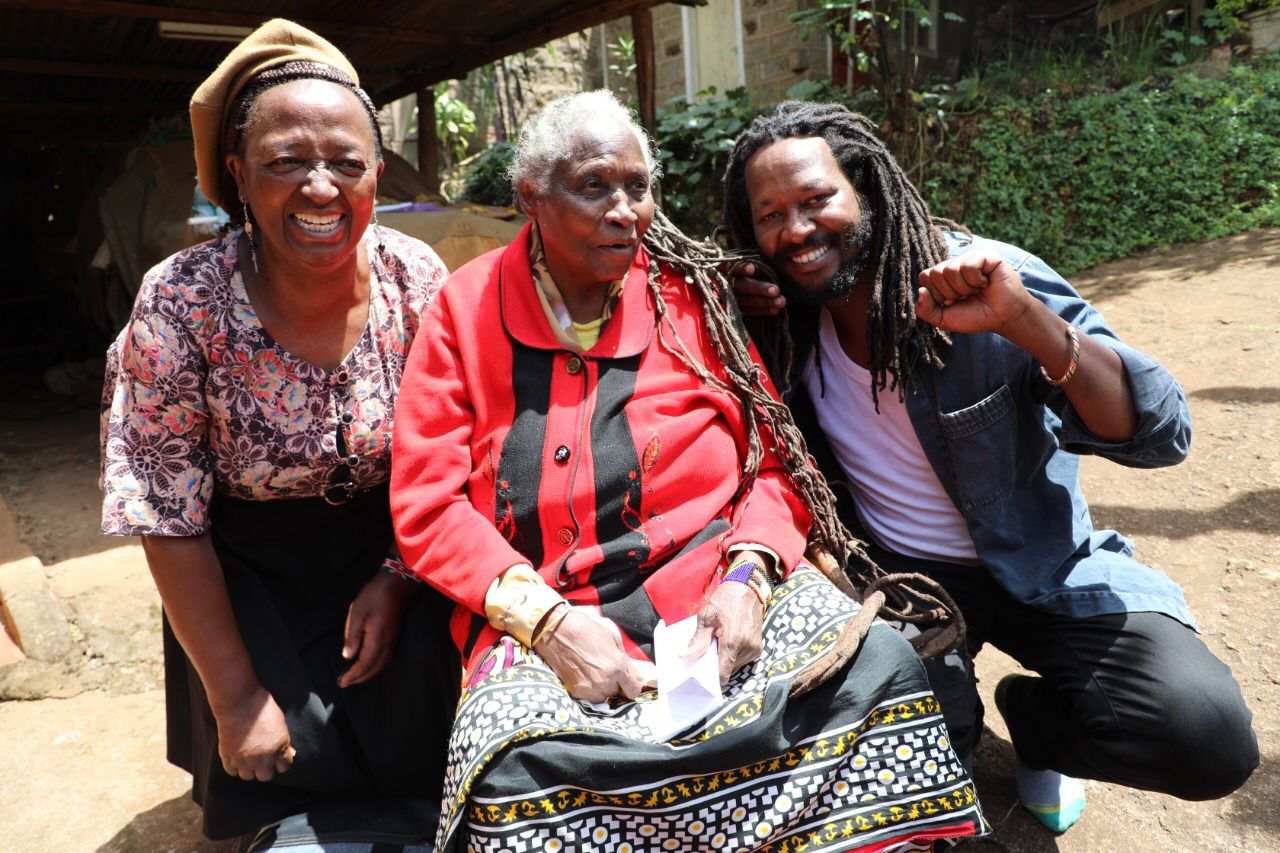 Three people smiling together outdoors