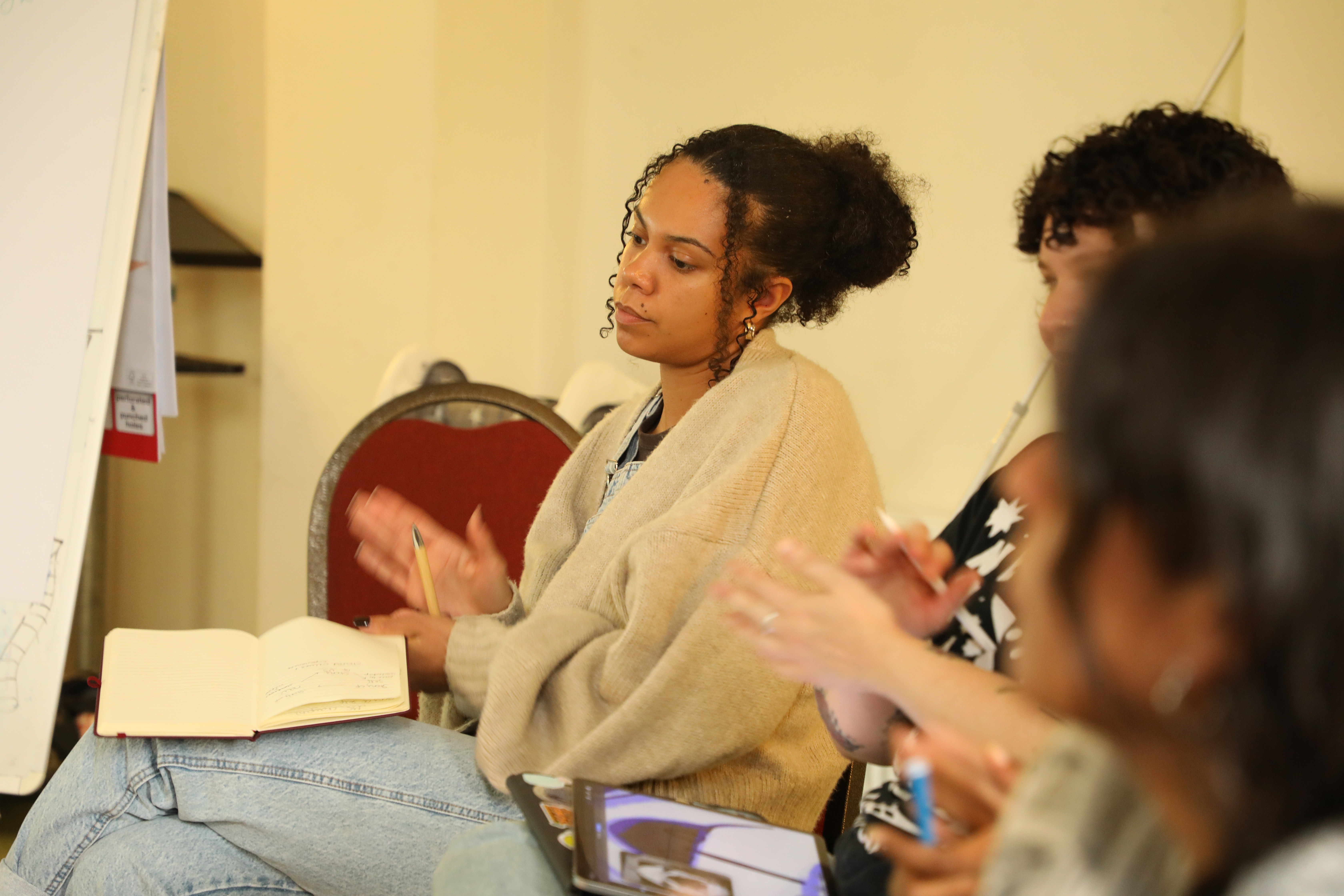 Young woman taking notes at workshop